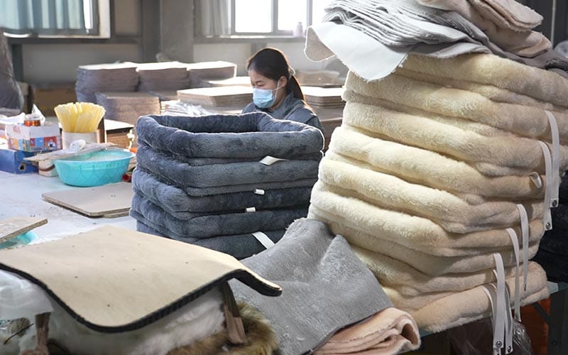 Plush bed components at a production workstation